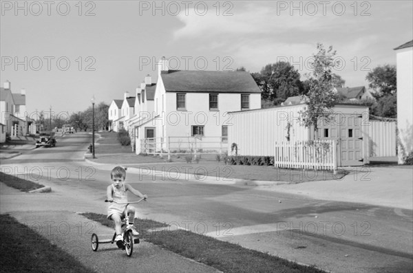 Young Boy Riding Tricycle, Greendale, Wisconsin, USA, a Greenbelt Community Constructed by U.S. Department of Agriculture as Part of President Franklin Roosevelt's New Deal, John Vachon for U.S. Resettlement Administration, September 1939