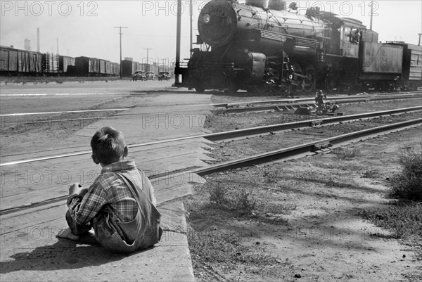 Rear View of Young Boy Watching Freight Train go by, Minneapolis, Minnesota, USA, John Vachon for U.S. Resettlement Administration, September 1939