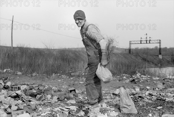 Man Foraging for Food at City Dump, Dubuque, Iowa, USA, John Vachon for Farm Security Administration, April 1940