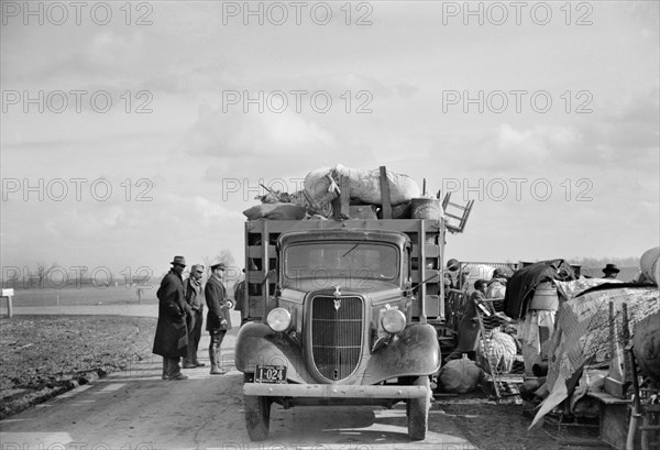 State Highway Officials Moving Evicted Sharecroppers Away from Roadside to Area between Levee and Mississippi River, New Madrid County, Missouri, USA, Arthur Rothstein for Farm Security Administration, January 1939