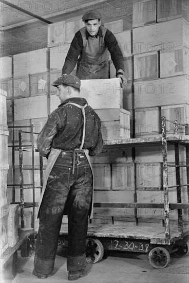 Two Workers Storing Crates of Eggs in Cold Storage Warehouse, Jersey City, New Jersey, USA, Arthur Rothstein for Farm Security Administration, January 1939