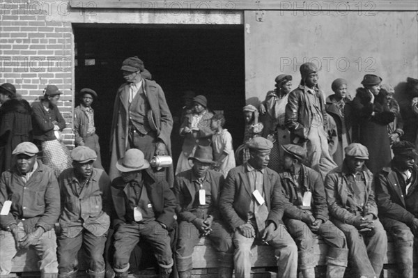 African-American Flood Refugees Wearing Identification Tags after Registration in the Flood Refugee Camp, Forrest City, Arkansas, USA, Edwin Locke for U.S. Resettlement Administration, February 1937