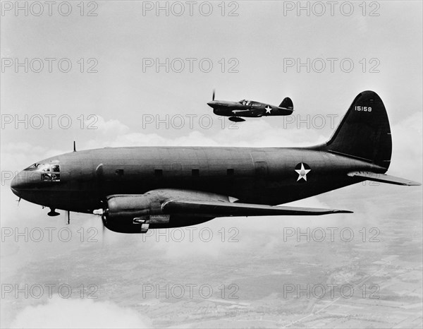 C-46 Transport Plane with P-40 Single-Engine Fighter Plane in Background, Office of War Information, March 1943