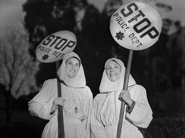 Mrs. E.K. Sabel and Mrs. J.R. Harris, members of the Women's Safety Traffic Reserve, on duty Guarding School Crossing during School Hours, Oakland, California, USA, Ann Rosener for Office of War Information, February 1943