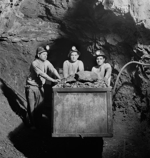 Three Miners Loading Mercury Ore into Mine Car by Hand, Quicksilver Mining Company, New Idria, California, USA, Andreas Feininger for Office of War Information, December 1942