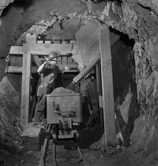 Worker Loading Mercury Ore from Chute into Mine Car, Quicksilver Mining Company, New Idria, California, USA, Andreas Feininger for Office of War Information, December 1942