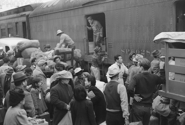 Japanese-Americans Gathering around Baggage Car During Evacuation of Japanese-Americans from West Coast Areas under U.S. Army War Emergency Order, Los Angeles, California, USA, Russell Lee, Office of War Information, April 1942
