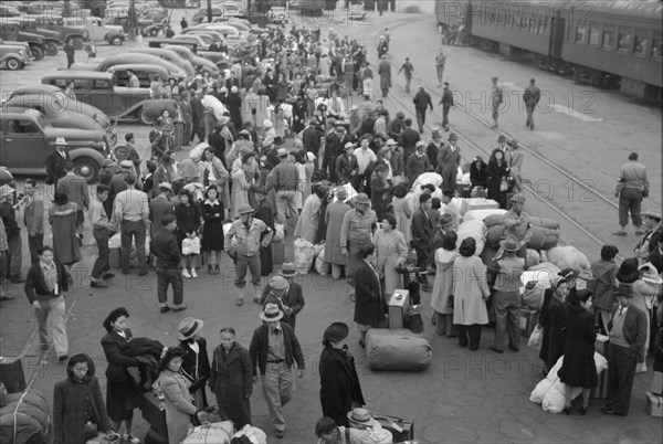 Japanese-Americans Waiting for Train to Owens Valley During Evacuation of Japanese-Americans from West Coast Areas under U.S. Army War Emergency Order, Los Angeles, California, USA, Russell Lee, Office of War Information, April 1942