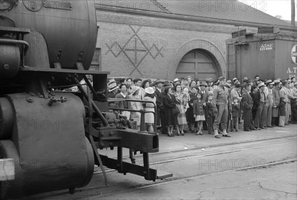 Japanese-Americans Waiting for Train to Owens Valley During Evacuation of Japanese-Americans from West Coast Areas under U.S. Army War Emergency Order, Los Angeles, California, USA, Russell Lee, Office of War Information, April 1942