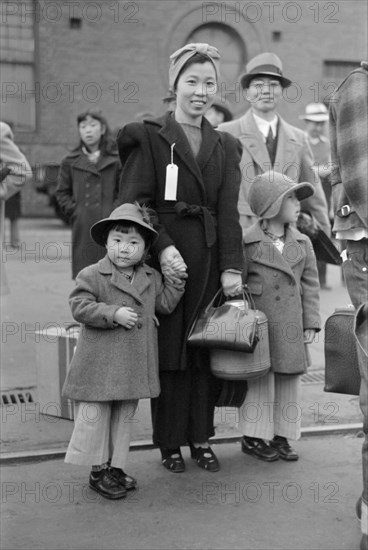 Japanese-American Mother and Daughter Waiting for Train to Owens Valley During Evacuation of Japanese-Americans from West Coast Areas under U.S. Army War Emergency Order, Los Angeles, California, USA, Russell Lee, Office of War Information, April 1942