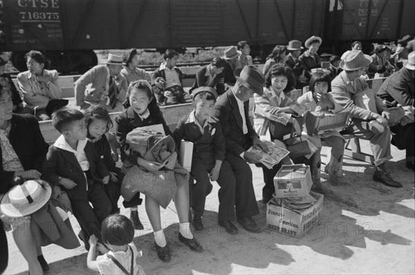 Japanese-Americans Waiting for Registration at Reception Center During Evacuation of Japanese-Americans from West Coast Areas under U.S. Army War Emergency Order, Santa Anita, California, USA, Russell Lee, Office of War Information, April 1942