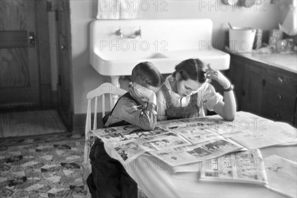 Children Reading Sunday Newspaper, Family of Tenant Farmer, Dickens, Iowa, USA, Russell Lee, U.S. Resettlement Administration, December 1936