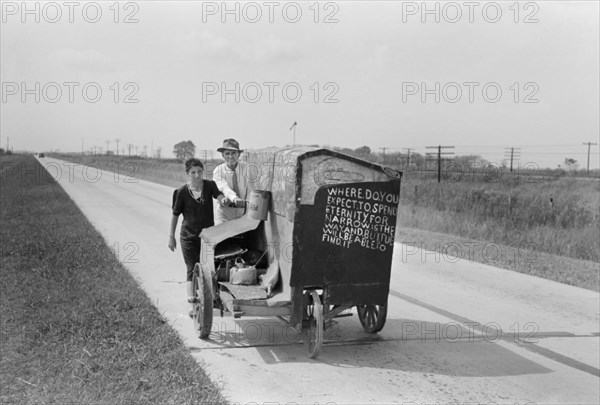 Traveling Evangelists Pushing Cart on Road between Lafayette and Scott, Louisiana, USA, Russell Lee, Farm Security Administration, October 1938