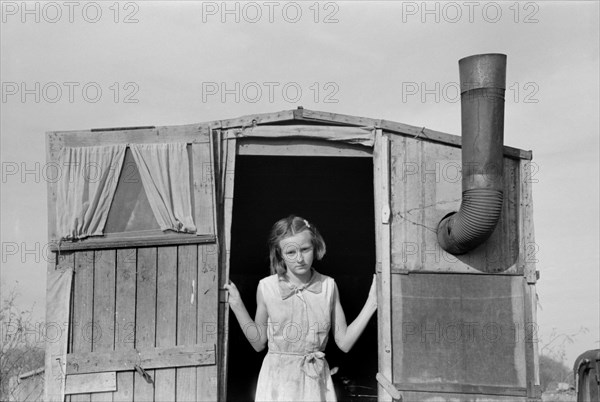 Daughter of Migrant Farmer in Doorway of Trailer, Sebastin, Texas, USA, Russell Lee, Farm Security Administration, February 1939