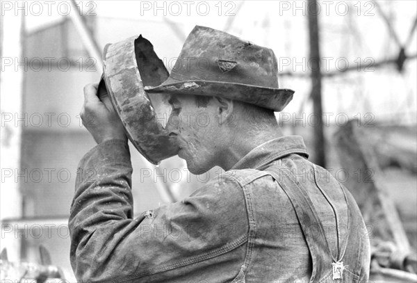 Oil Field Worker Drinking Water, Kilgore, Texas, USA, Russell Lee, Farm Security Administration, April 1939