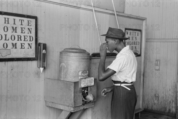 Man Drinking Water at "Colored" Water Cooler in Bus Terminal, Oklahoma City, Oklahoma, USA, Russell Lee, Farm Security Administration, July 1939