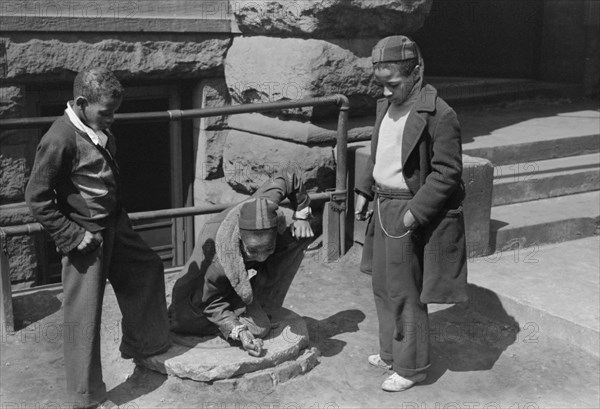 Three Boys Playing Marbles, South Side, Chicago, Illinois, USA, Russell Lee, Farm Security Administration, April 1941