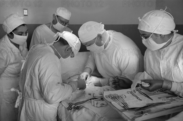 Surgeons Operating on Patient, Cairns General Hospital, FSA Farmworkers Community, Eleven Mile Corner, Arizona, USA, Russell Lee, Farm Security Administration, February 1942