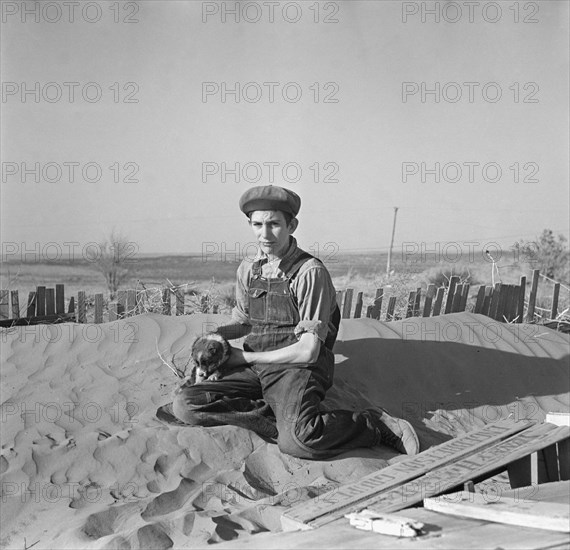 Farmer' Son Playing on Soil Drift that Threatens to cover up his Home, Liberal, Kansas, USA, Arthur Rothstein, Farm Security Administration, March 1936