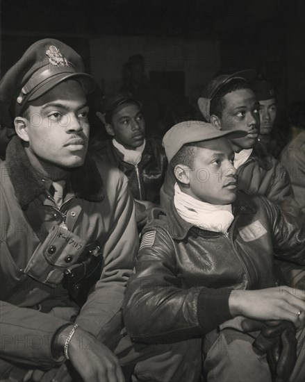 Members of 332nd Fighter Group Attending a Briefing, from left to right: Robert W. Williams, Ottumwa, IA, Class 44-E; William H. Holloman, III, St. Louis, Mo., Class 44; Ronald W. Reeves, Washington, D.C., Class 44-G; Christopher W. Newman, St. Louis, MO, Class 43-I; Walter M. Downs, New Orleans, LA, Class 43-B, Ramitelli, Italy, Toni Frissell, March 1945