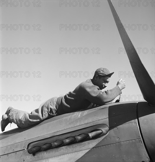 Crew Chief Marcellus G. Smith of Louisville, Kentucky, 100th F.S., Working on Airplane, Ramitelli, Italy, Toni Frissell, March 1945
