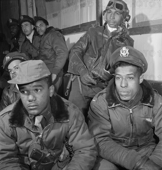 Tuskegee Airmen Attending Briefing, Foreground (left to right): Joseph L. "Joe" Chineworth, Memphis, TN, Class 44-E; Emile G. Clifton, San Francisco, CA, Class 44-B; Richard S. Harder, Brooklyn, NY, Class 44-B. Along back wall (back to front): Frank N. Wright, Elmsford, NY, Class 44-F; Robert J. Murdic, Franklin, TN, Class 44-F; Jimmie D. Wheeler, Ramitelli, Italy, Toni Frissell, March 1945