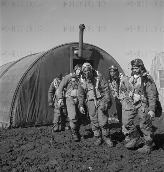 Tuskegee Airmen Leaving Parachute Room, Left to right: Richard S. Harder, Brooklyn, NY, Class 44-B; Unidentified Airman; Thurston L. Gaines, Jr., Freeport, NY, Class 44-G; Newman C. Golden, Cincinnati, OH, Class 44-G; Wendell M. Lucas, Fairmont Heights, MD, Class 44-E, Ramitelli, Italy, Toni Frissell, March 1945