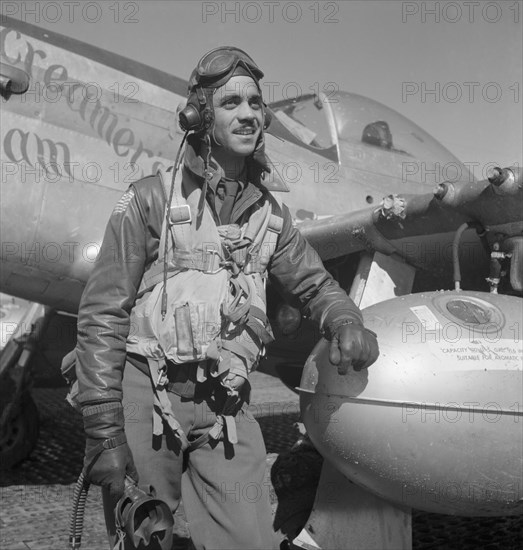 Tuskegee Airman Edward C. Gleed of Lawrence, Kansas, Class 42-K, Group Operations Officer, Three-quarter Length Portrait, Wearing Flight Gear, with Left Arm Resting on Airplane at Air Base, Ramitelli, Italy, Toni Frissell, March 1945