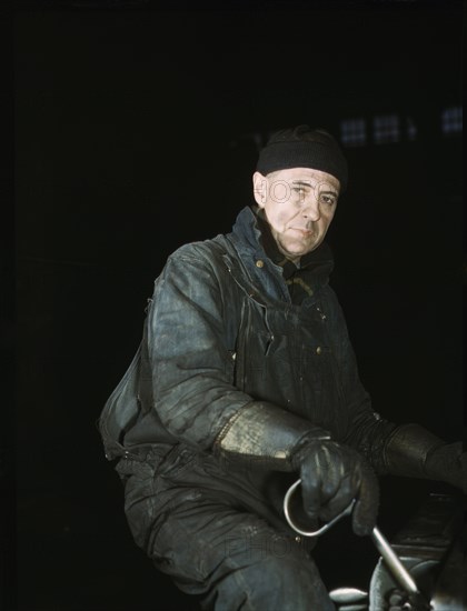 Worker in Roundhouse at Chicago & Northwestern Transportation Company, Proviso Yards, Melrose Park, Illinois, USA, Jack Delano for Office of War Information, 1942