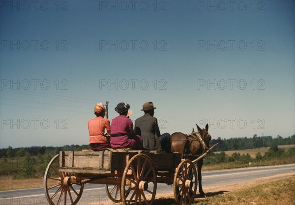 Three People Going to Town in Horse-Drawn Wagon on Saturday Afternoon, Greene County, Georgia, USA, by Jack Delano for Farm Security Administration, May 1941