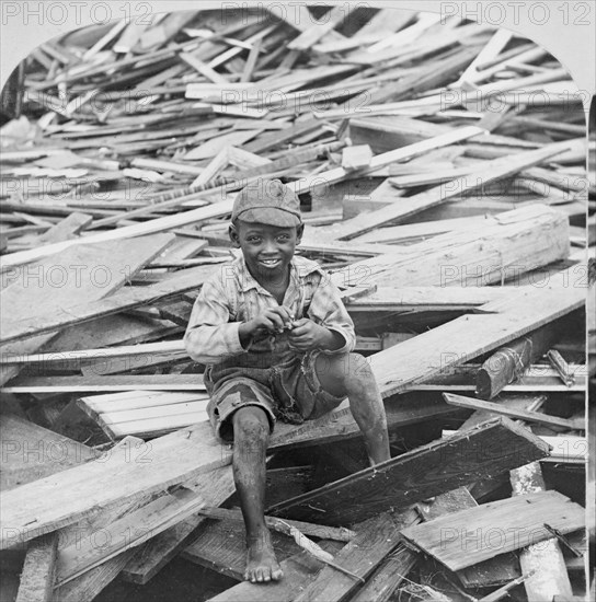 Portrait of Young Boy Sitting on Pile of Debris after Hurricane, Galveston, Texas, USA, Single Image of Stereo Card, 1900