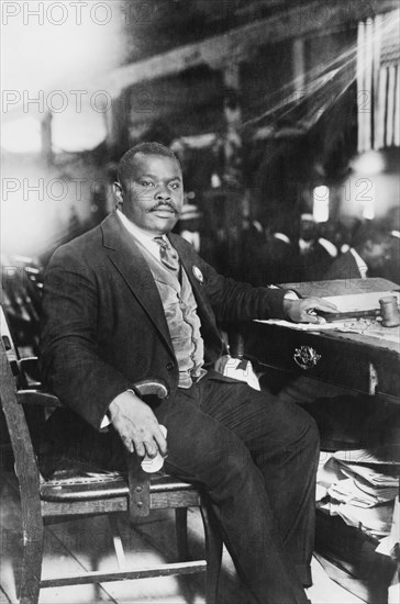 Marcus Garvey (1887-1940), Jamaican-Born Activist, Political Leader, Publisher, Entrepreneur and Proponent of Black Nationalism and Pan-Africanism Movements, Full-length Portrait seated at Desk, Bain News Service, 1924