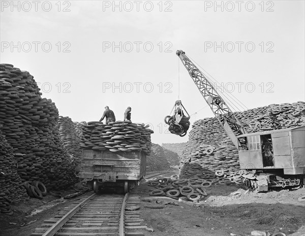 Workers Stacking Discarded Tire Casings at Recovery Plant with the Reclaimed Material to be Manufactured into Thousands of Essential Mechanical Rubber Products, Firestone Tire and Rubber Company, Akron, Ohio, USA, Alfred T. Palmer for Office of War Information, December 1942