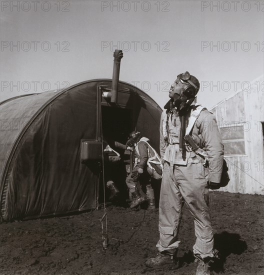 Pilot Newman C. Golden, Cincinnati, OH, Class 44-G, Scanning Skies, with Parachute Room in Background, Ramitelli, Italy, Toni Frissell, March 1945