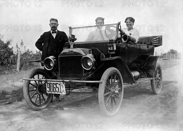 Two Men and a Woman with a Ford Model T Automobile, circa 1914