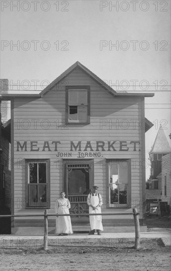 Two People Standing in Front of Meat Market, USA, circa 1900