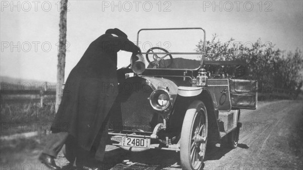 Man Pouring Water in Radiator of Automobile, circa 1912