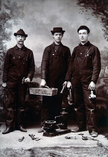 Three Plumbers Holding Their Tools, circa 1895