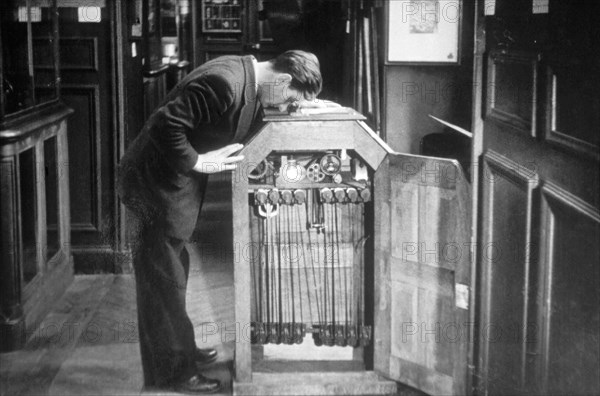 Man Looking into a Kinetoscope, Invented by Thomas A. Edison in 1889