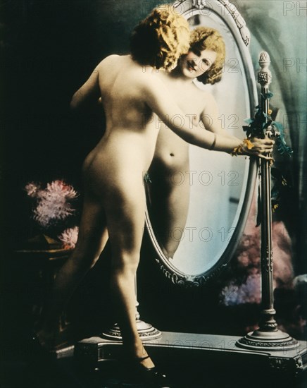 Standing Nude Woman Looking into Full Length Mirror, Hand colored Photograph, circa 1927