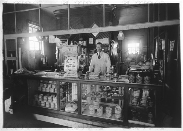 Clerk Standing by Cash Register in Grocery Store, 1929