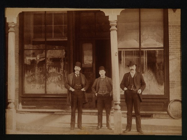 Three Men Standing in Front of Liquor Store, Aylmer, Ontario, Canada, 1900