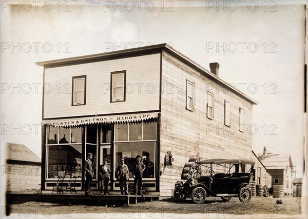 Four Men in Front of Hardware Store, Portrait, circa 1915