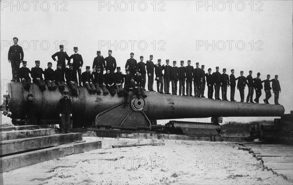 Group of Men Sitting on Barrel of Large Railroad Gun, WWI, circa 1910's