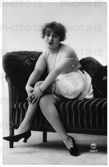 French Lingerie Model Seated on Chaise Lounge, Hands on Knees, circa 1920