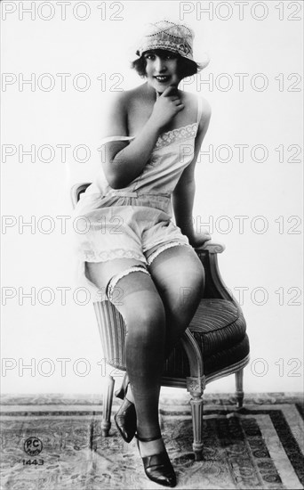 French Lingerie Model Sitting on Arm of Chair, 1920