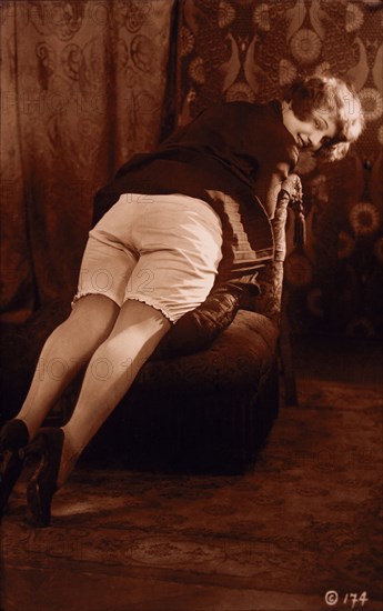 French Lingerie Model Laying Over Chair to Reveal Bloomers, Rear View, 1915