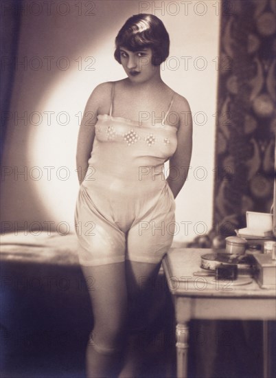French Lingerie Model Standing Next to Bed, 1915