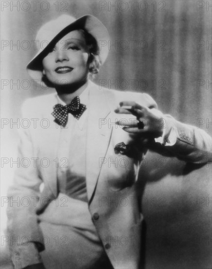 Marlene Dietrich in White Suit Smoking Cigarette, Studio Portrait, 1932