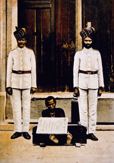 Criminal Guarded by Two Sikh Soldiers, Hong Kong, Hand-Colored Photograph, circa 1900
